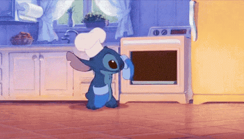a cartoon character wearing a chef 's hat is standing in front of an oven in a kitchen