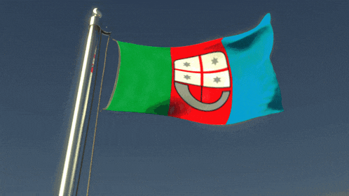 a red green and blue flag with a shield on it is waving in the wind