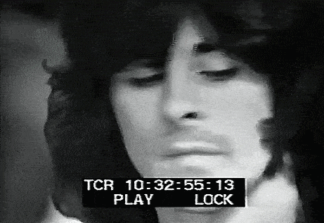 a black and white photo of a man 's face with a tcr play lock displayed above it