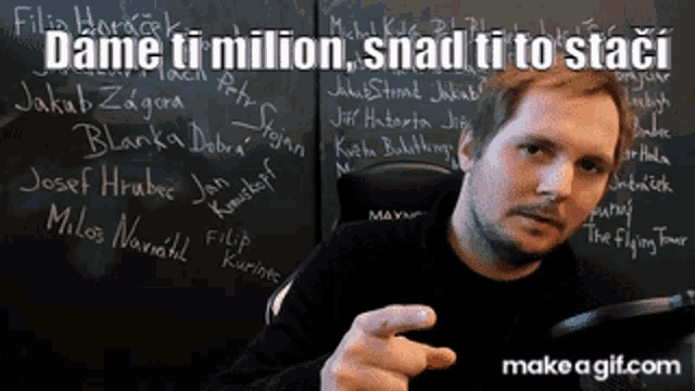 a man pointing in front of a chalkboard that says dame ti milion snad ti to staci