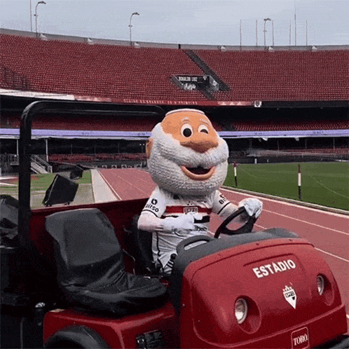 a mascot is driving a red toro stadium vehicle
