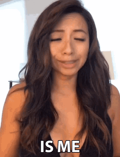 a woman in a black top says " is me " with her eyes closed