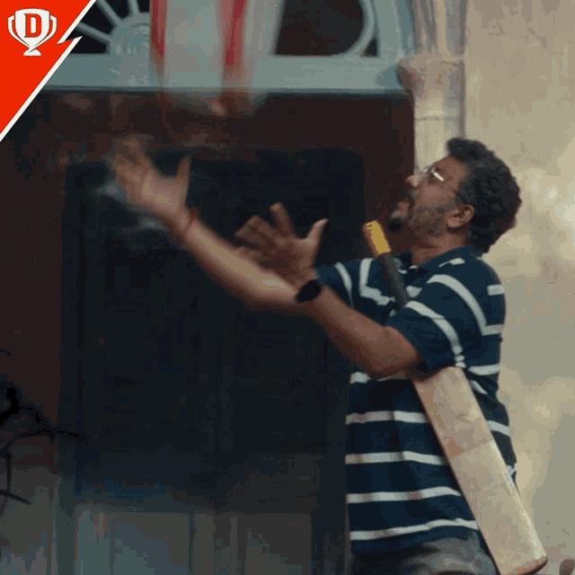 a man holding a cricket bat is throwing a ball