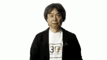 a man wearing a shirt with the number 30 on it is standing next to a toy yoshi