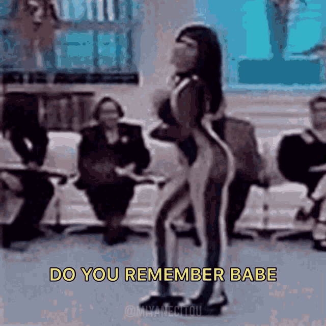 a woman in a swimsuit is dancing with the words do you remember babe written above her
