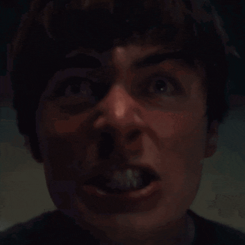 a close up of a man screaming with his mouth wide open