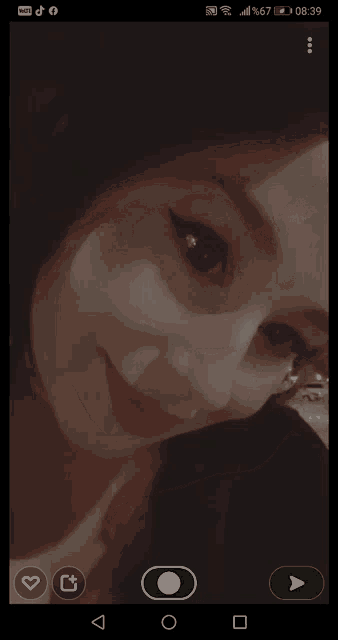 a screenshot of a woman 's face on a cell phone