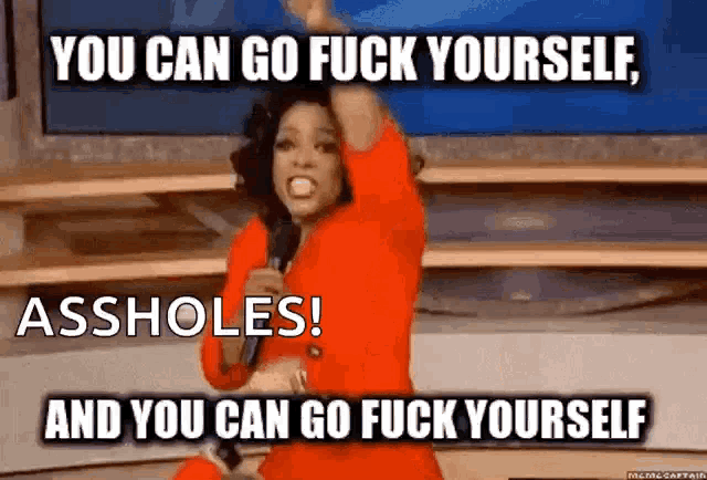 a woman in a red dress holds a microphone and says you can go fuck yourself assholes and you can go fuck yourself