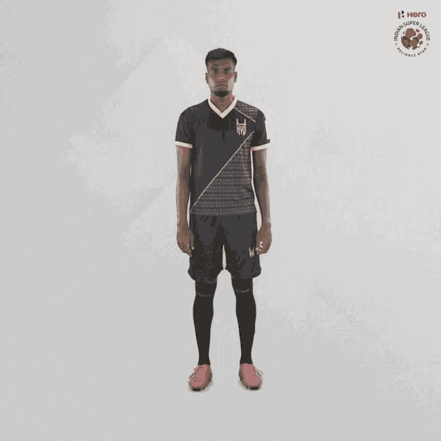 a man is wearing a black and gold soccer uniform