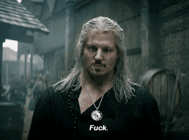 a man wearing a black shirt that says fuck