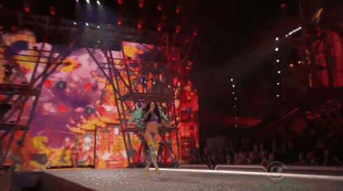 a woman walking down a runway at a fashion show