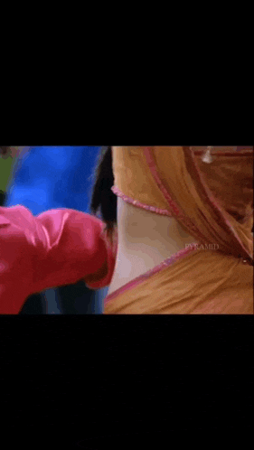 a close up of a woman 's back in a yellow and pink dress .