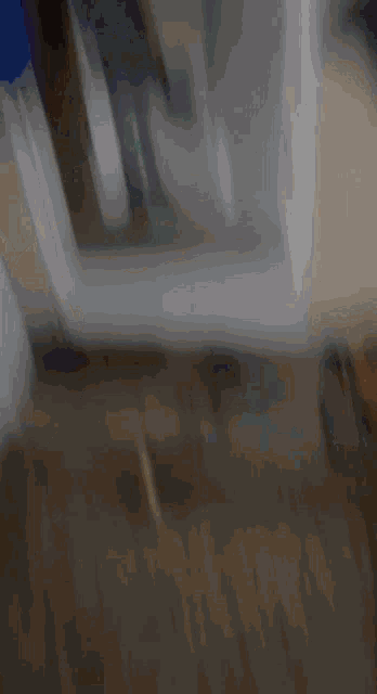 a person in a blue shirt is standing in front of a mirror