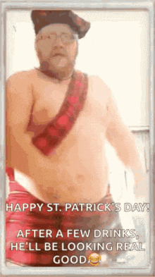 a shirtless man wearing a kilt and a hat is standing in a kitchen .