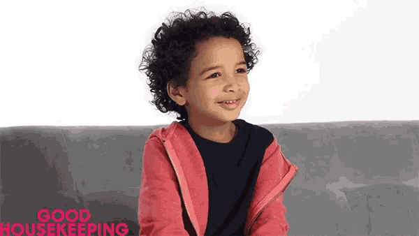 a little boy is sitting on a couch with the words good housekeeping written on the bottom