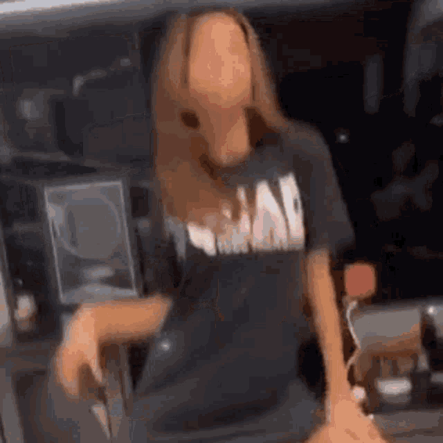 a woman wearing a black t-shirt with the word bad on it is dancing .