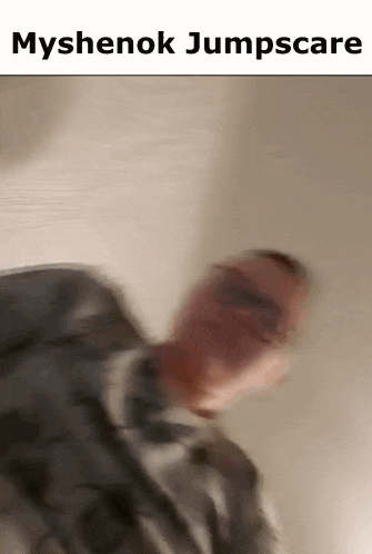 a blurry picture of a man with the words myshenok jumpscare on the bottom .