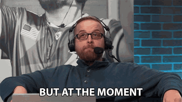 a man wearing headphones and glasses says " but at the moment "