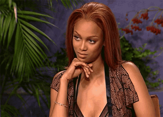 a woman with red hair is wearing a bracelet