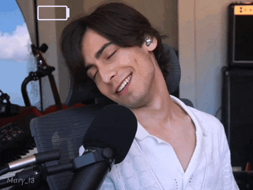 a man sitting in front of a microphone with the name mary_t8 on the bottom