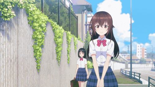 two anime girls are walking down a street