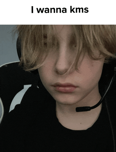 a boy wearing a headset with the words " i wanna kms " on the top