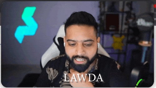 a man with a beard is sitting in a chair with the name lawda on the bottom
