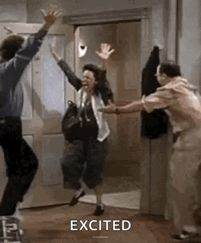 a woman is jumping in the air while a man holds her hands up in the air .