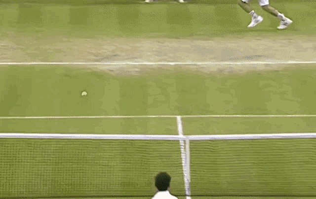 a man is playing tennis on a tennis court with a racket and a ball .