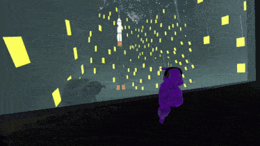a monkey wearing headphones looks out a window at a rocket