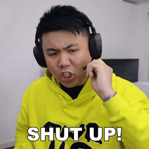 a man wearing headphones is making a funny face and saying shut up !