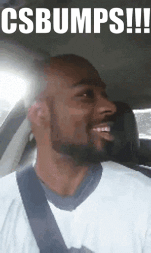 a man with a beard is smiling in a car with the words csbumps written above him