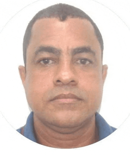 a man in a blue shirt is looking at the camera in a circle on a white background .