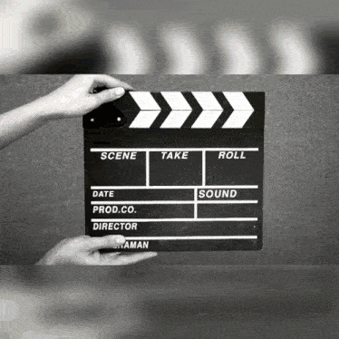 a person is holding a clapper board that says scene take roll sound and producer