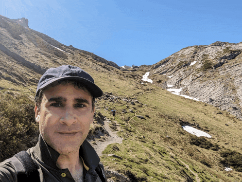 a man taking a selfie in the mountains