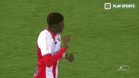 a soccer player in a red and white jersey with the number 3