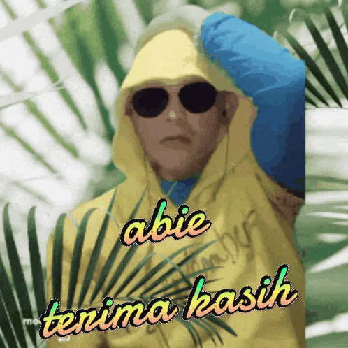 a man wearing sunglasses and a yellow hoodie says " abie terima kasih "