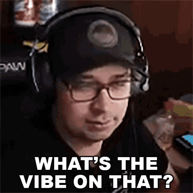 a man wearing headphones and a hat is asking what 's the vibe on that ?