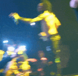 a blurry picture of a person wearing a black shirt with a white x on the back