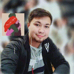 a man wearing ear buds and a jacket with a ny logo