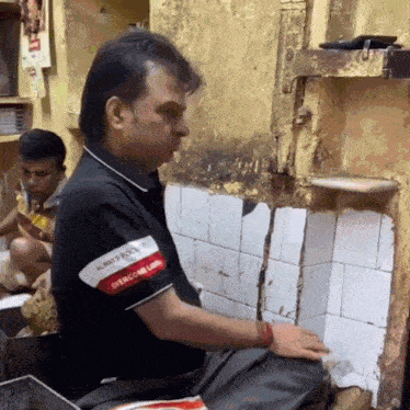 a man wearing a black shirt that says always focus overcome low