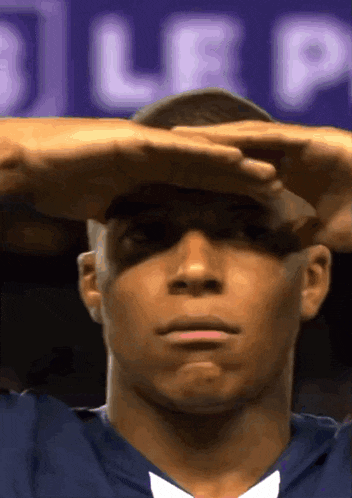 a close up of a man covering his face with his hands