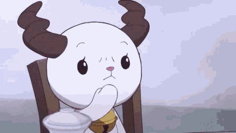 a cartoon character with horns is sitting at a table with his hand on his chin