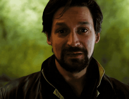 a man with a beard wearing a black jacket