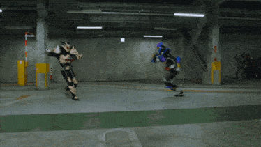 a man in a black suit is fighting another man in a purple suit