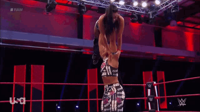 two women are wrestling in a ring with the word raw on the bottom of the screen