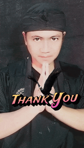a man wearing a black shirt with the word thank you written on it