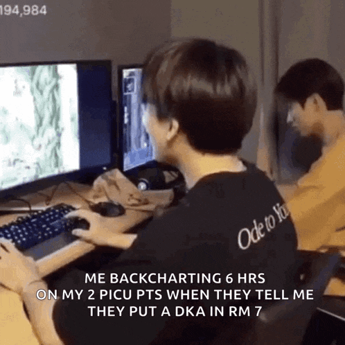 a man is playing a video game on a computer while another man watches .