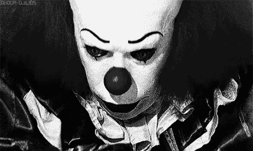 a black and white photo of a creepy clown .