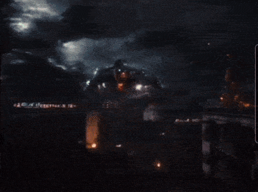 a giant robot is flying through the air at night